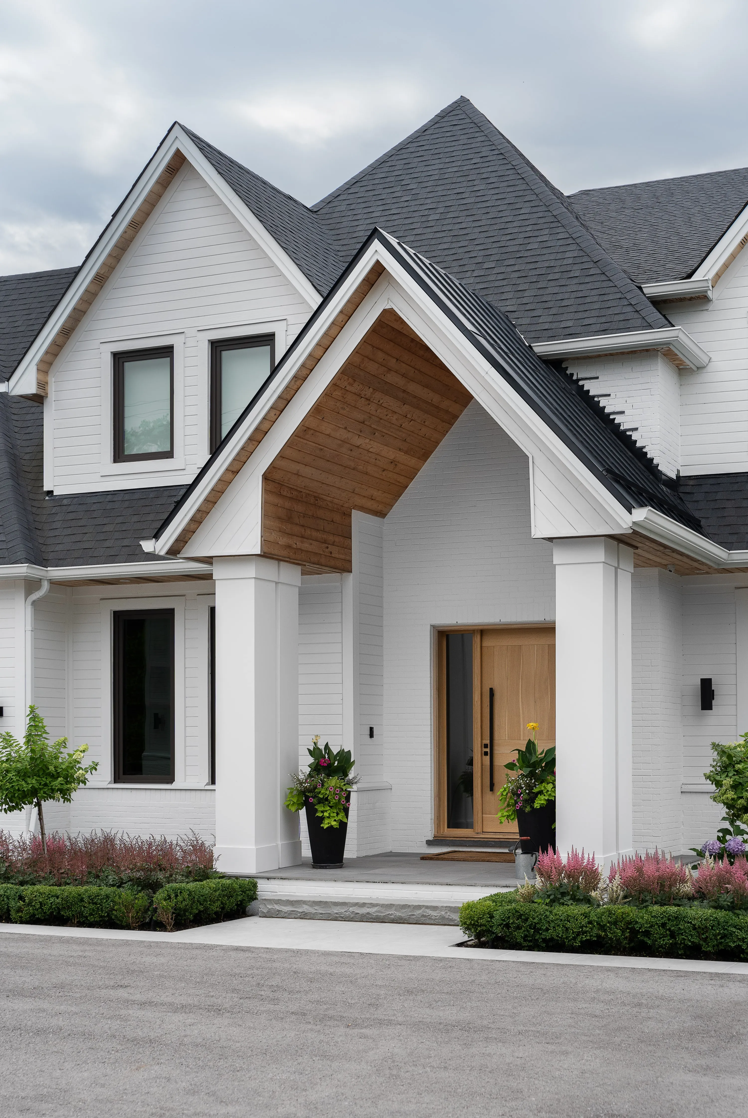 Covered entry with a cedar-lined gable and a timber door.