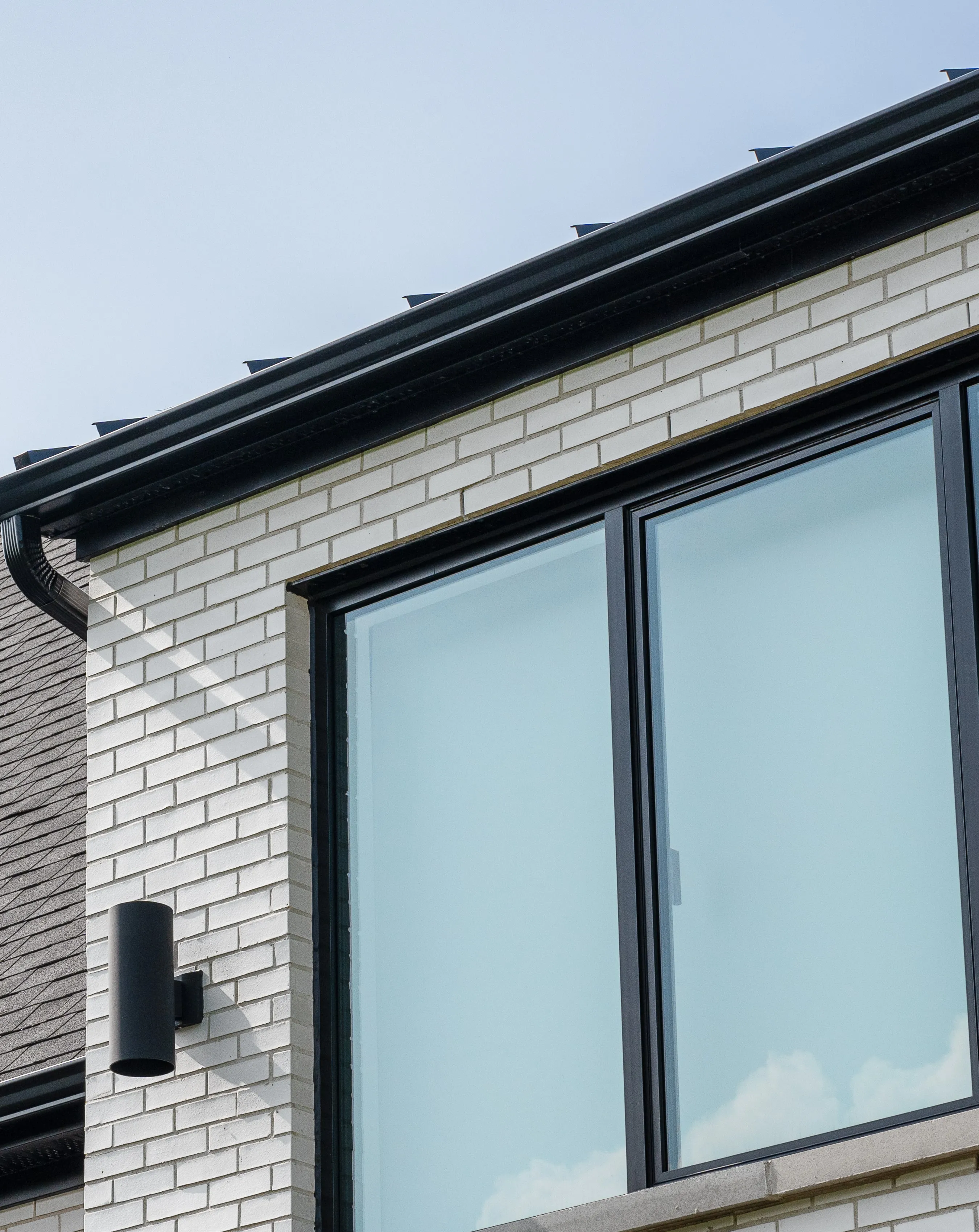 Brick, glazing and roofline detail at Cedar Valley Residence.