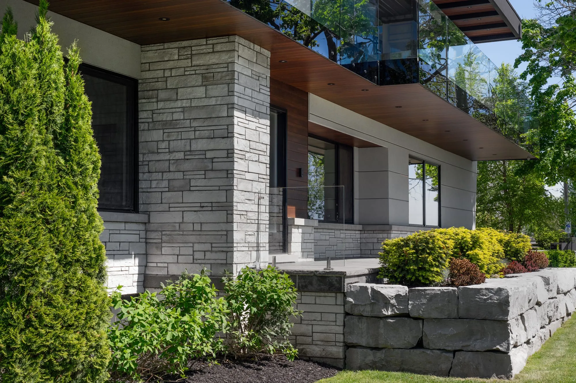 Stone courses and a timber soffit at Meadow Wood Residence.