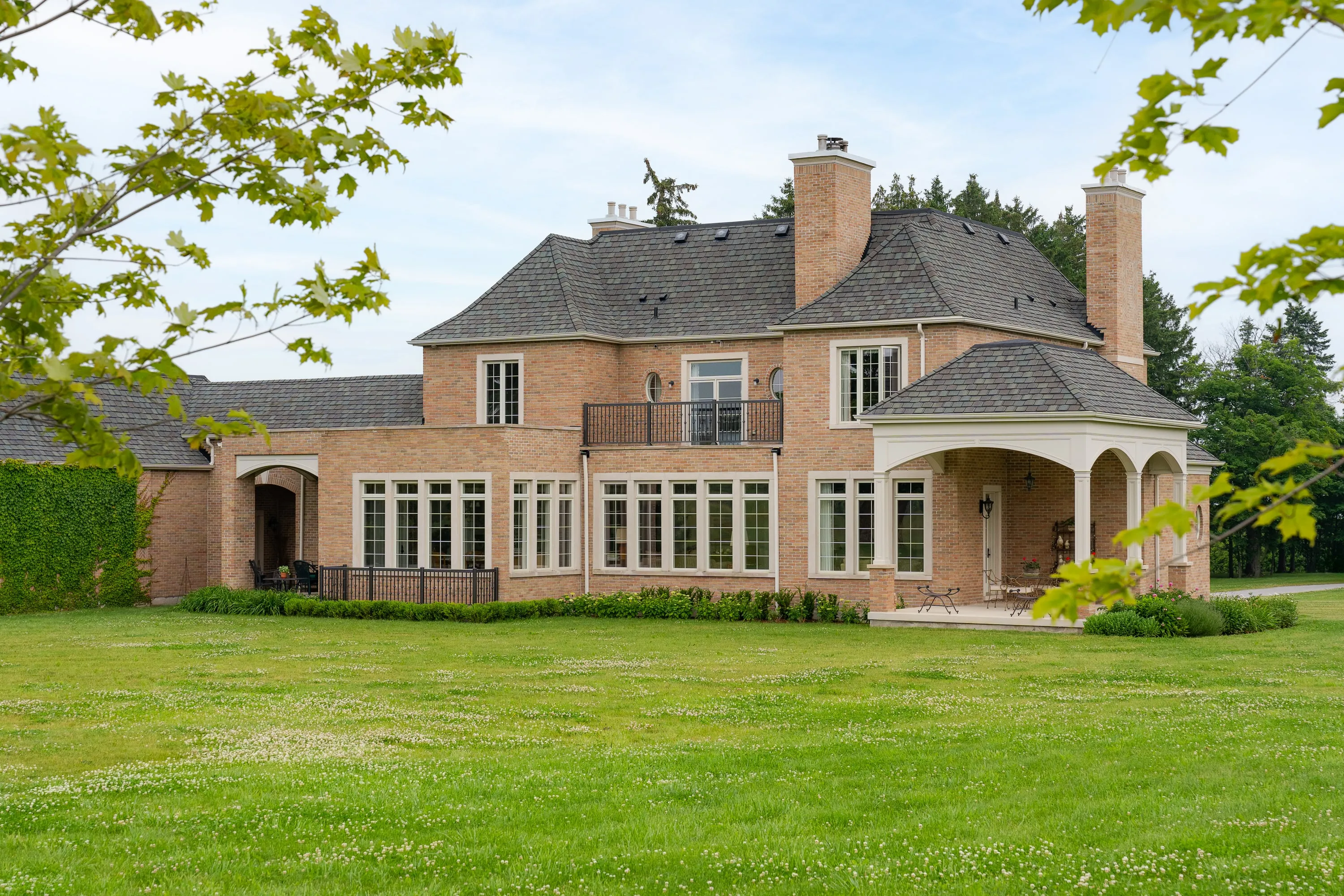 Garden elevation with tall glazing and a covered terrace.