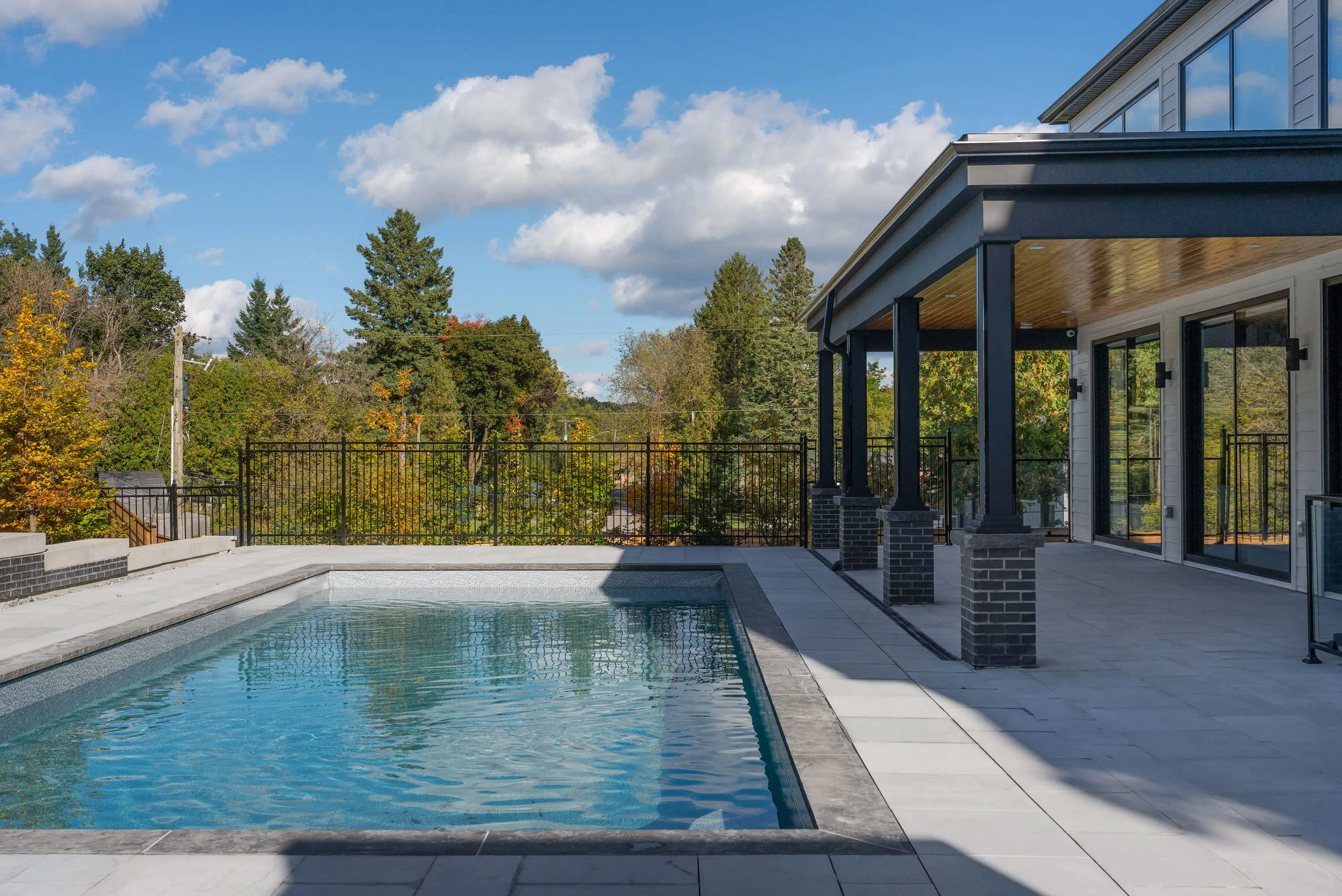 Pool house and terrace at dusk.
