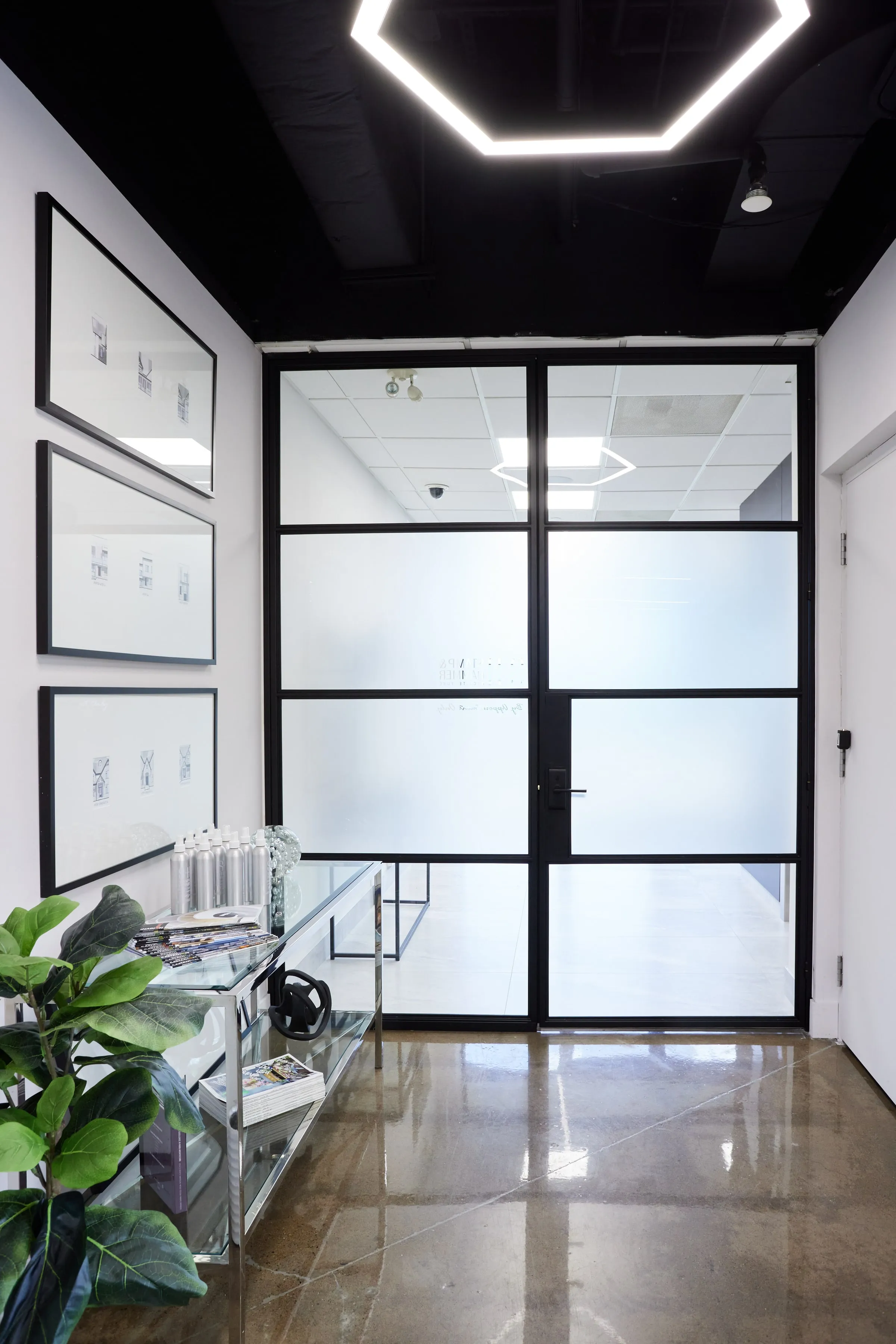 Black steel-framed glass door into the studio.