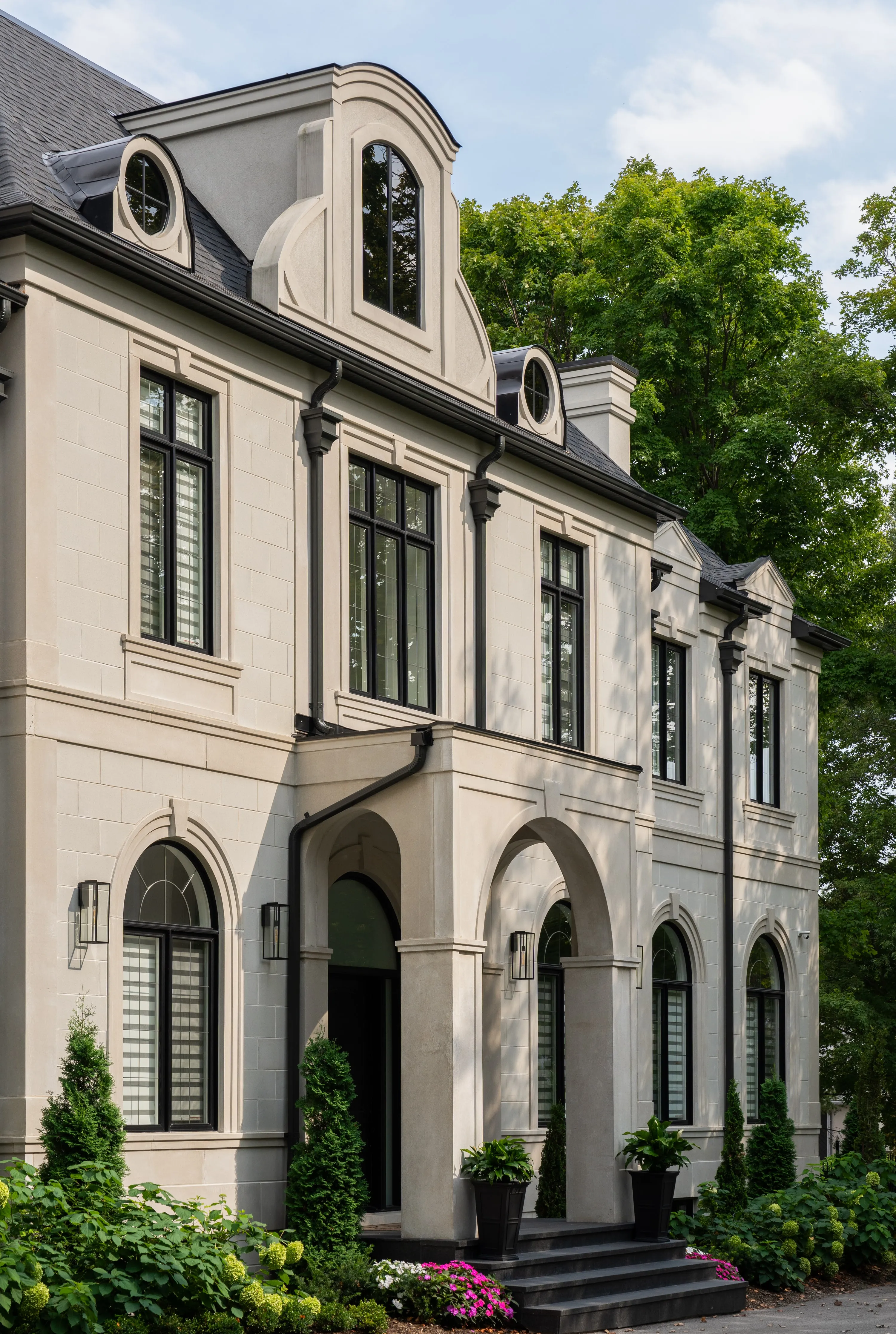 Arched entry with columns and lanterns.